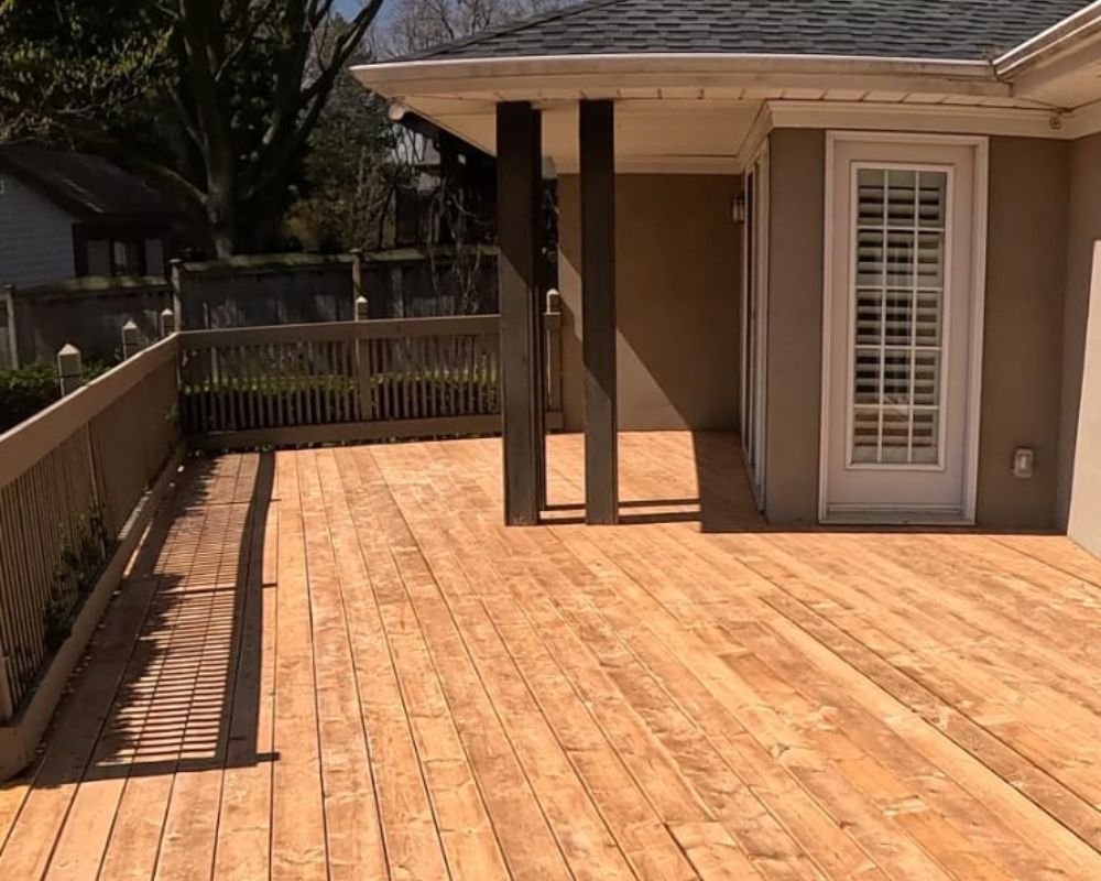 Completed large custom wood deck installation showcasing clean lines and immaculate carpentry work in Oakville.