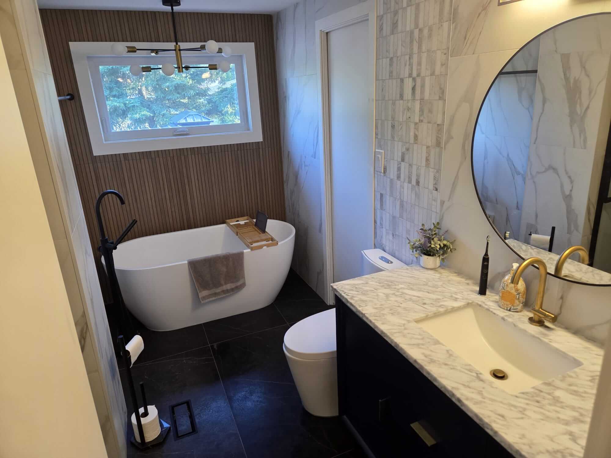 Full view of a modern master bathroom renovation in Oakville completed by Phil from Bespoke Handyman, featuring a freestanding tub and marble vanity.