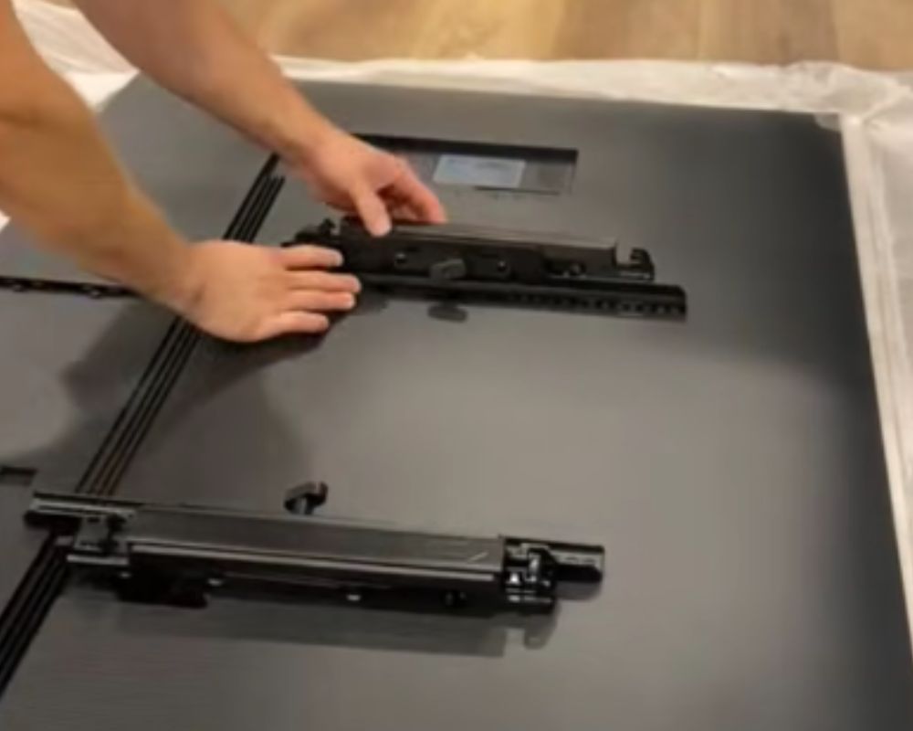 Close-up of secure bracket installation onto the back of a premium flat-screen television by Bespoke Handyman.