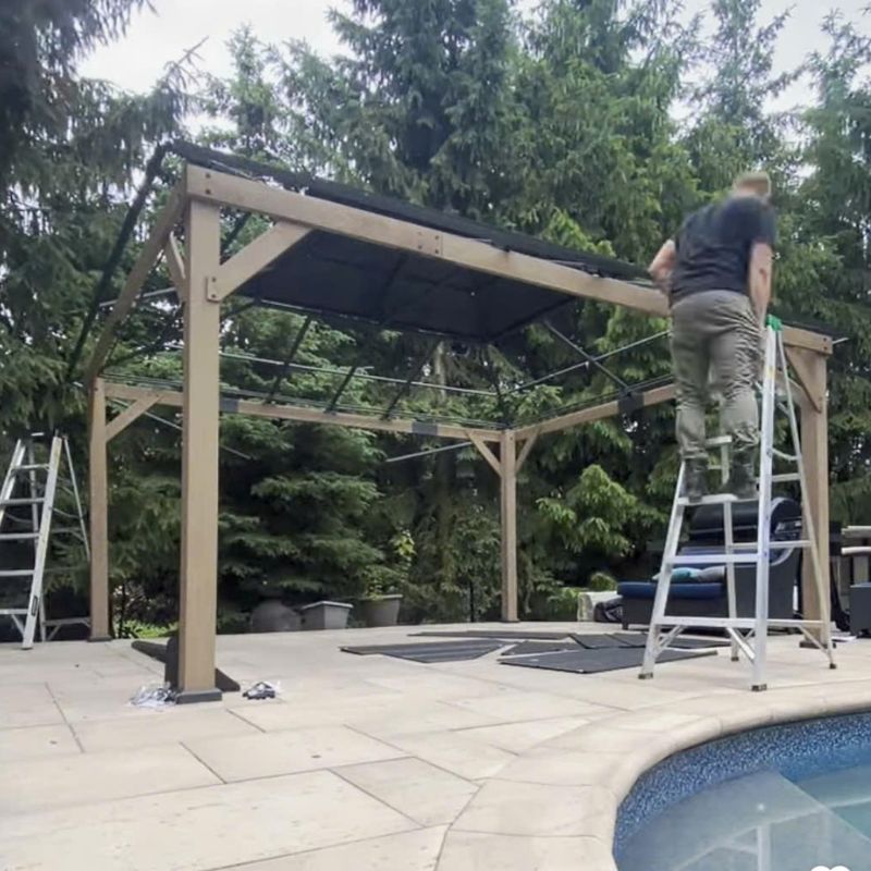 Bespoke Handyman team installing the roof frame of a Yardistry cedar gazebo by a swimming pool in Oakville